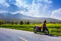 Photo of a motorbike parked on quiet road near Lake Huay Tueng Thao