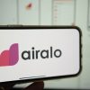 What is Airalo? Here is a view of airalo company logo on a handheld cell phone.